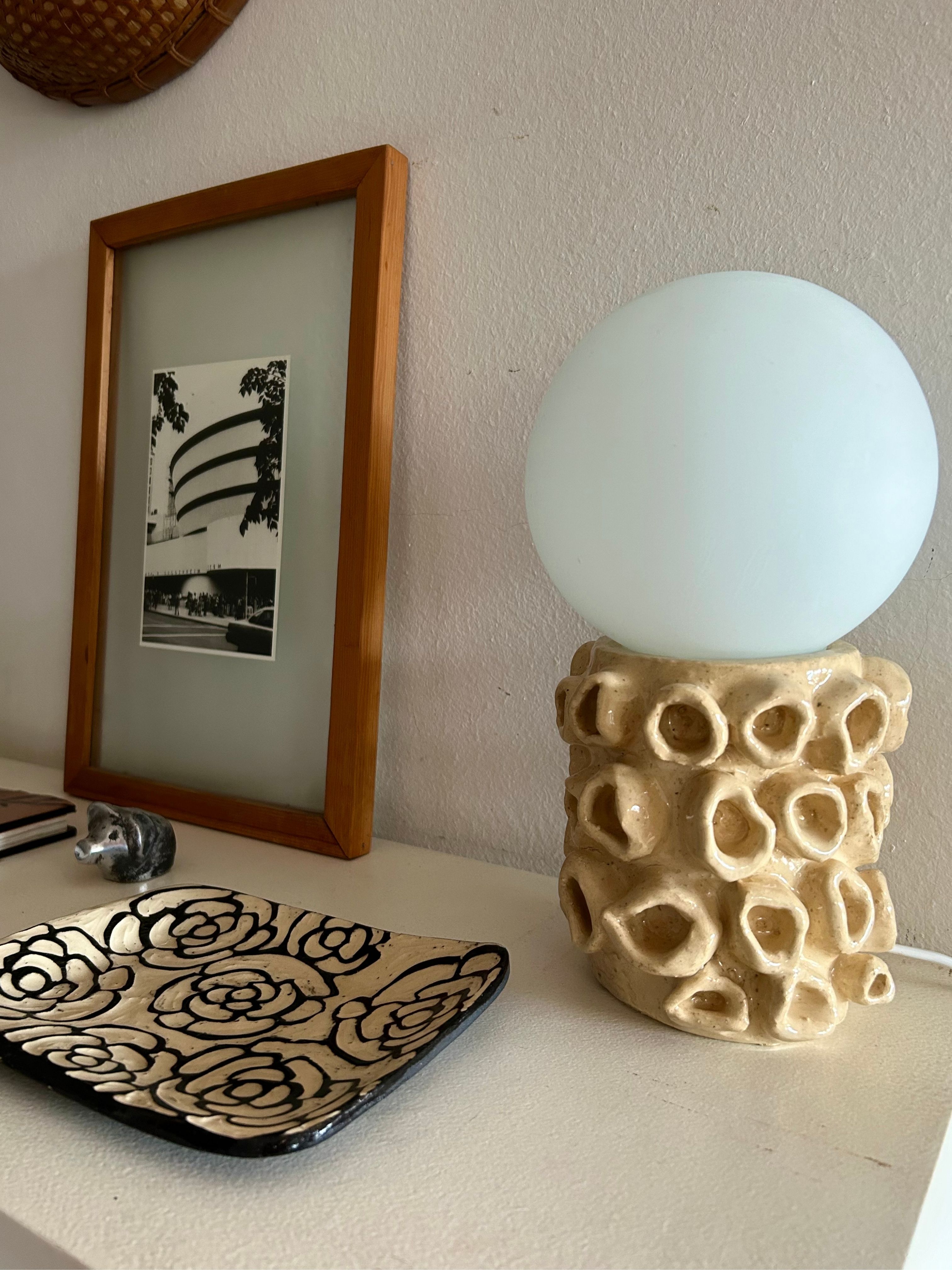 Textured ceramic lamp with round frosted globe